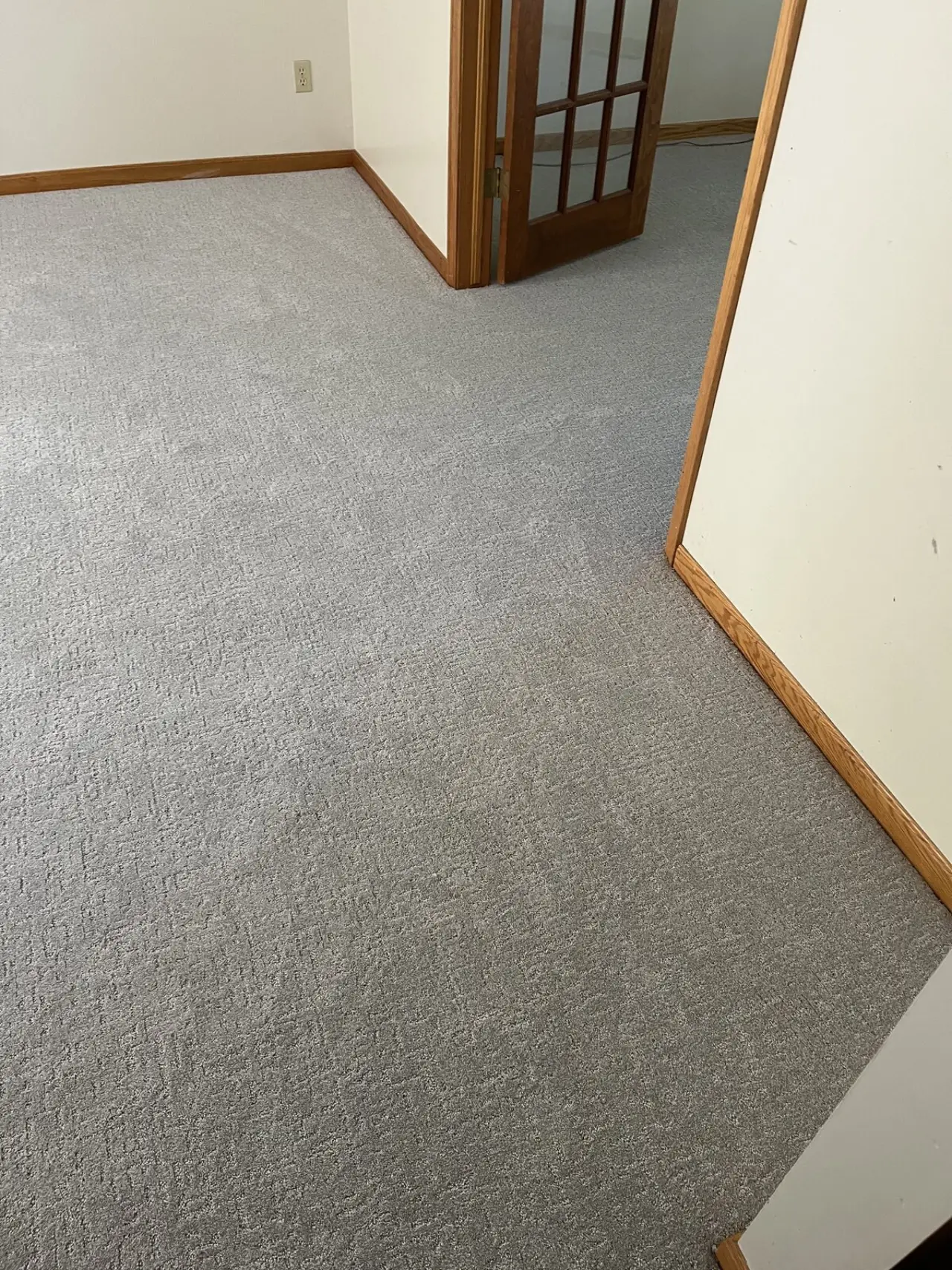 Carpet finished against warm wood trim