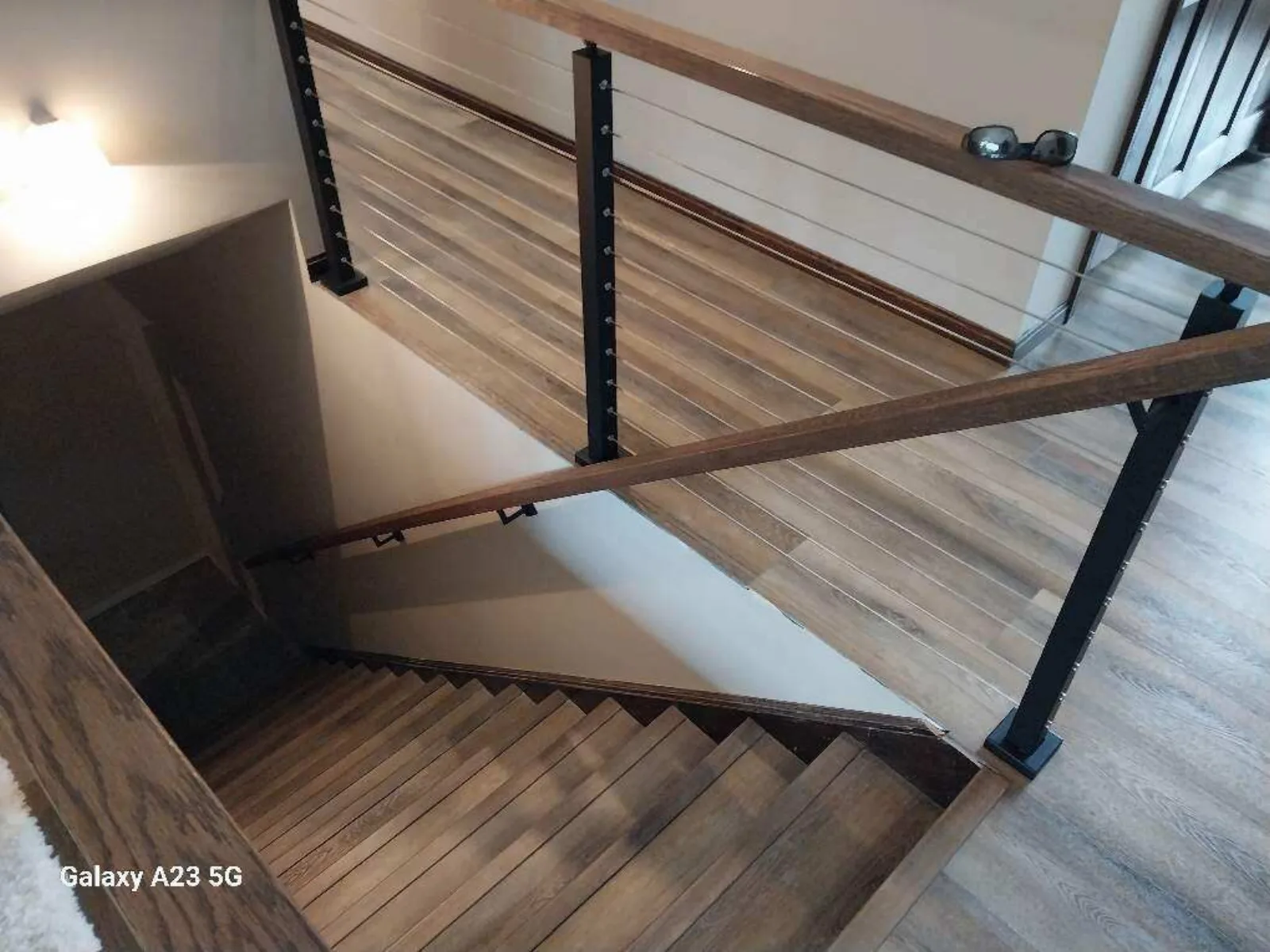 LVP stair landing with a modern railing