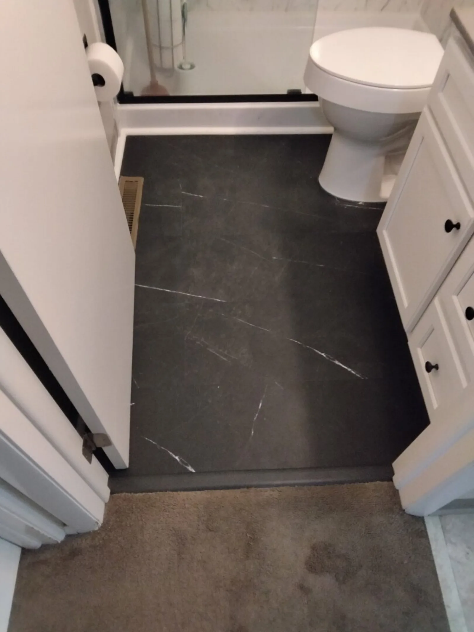 Dark marble-look bathroom tile